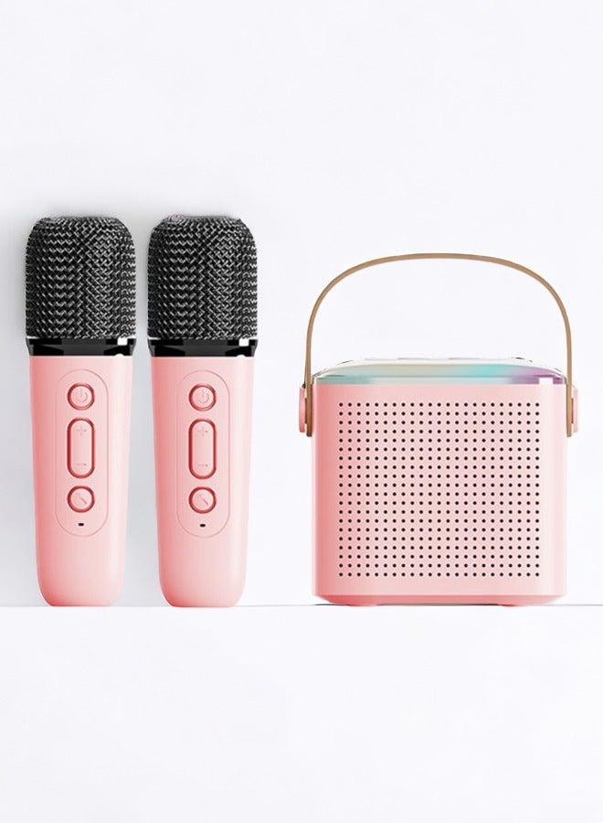 Pink kids karaoke machine with two wireless microphones, front angle