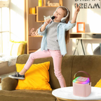 Child singing with the portable kids karaoke machine and wireless microphone at home
