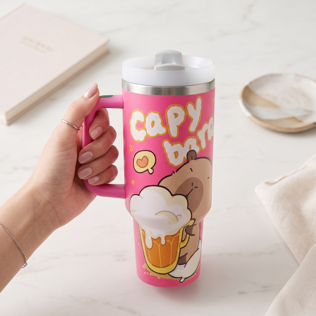 Hand holding 40 oz pink capybara tumbler