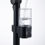 Removable 500ml water tank being filled, with touch control panel